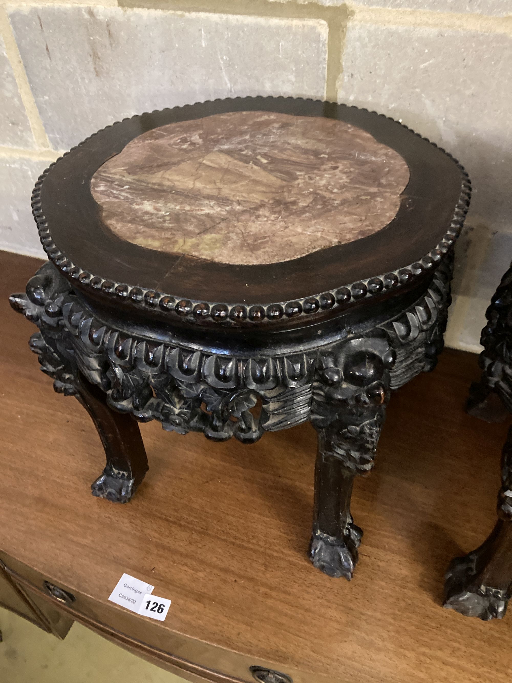 A pair of circular Chinese carved hardwood jardiniere stands, with rouge marble inset tops, 38cm diameter, height 38cm